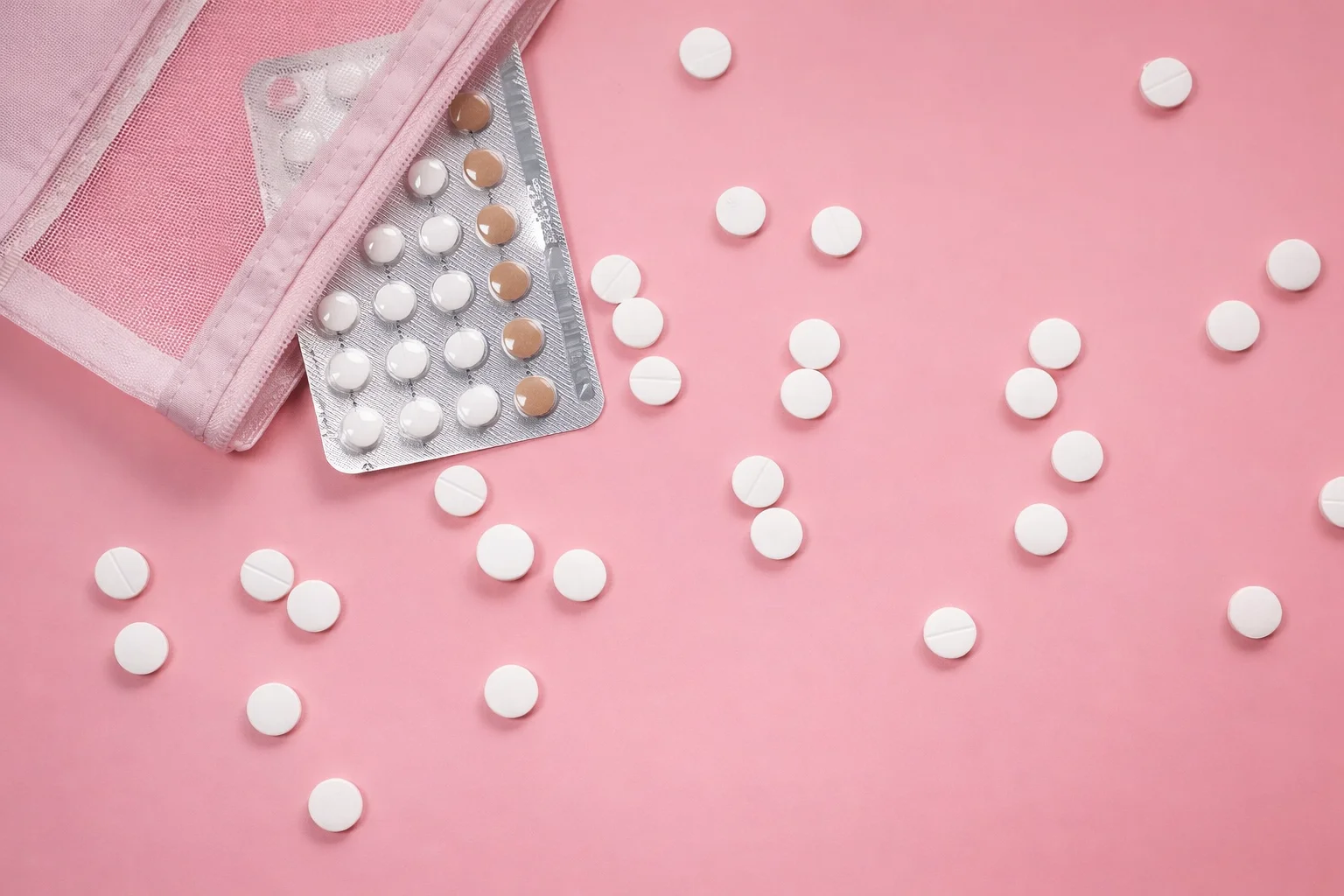 Pink pouch revealing medication pills