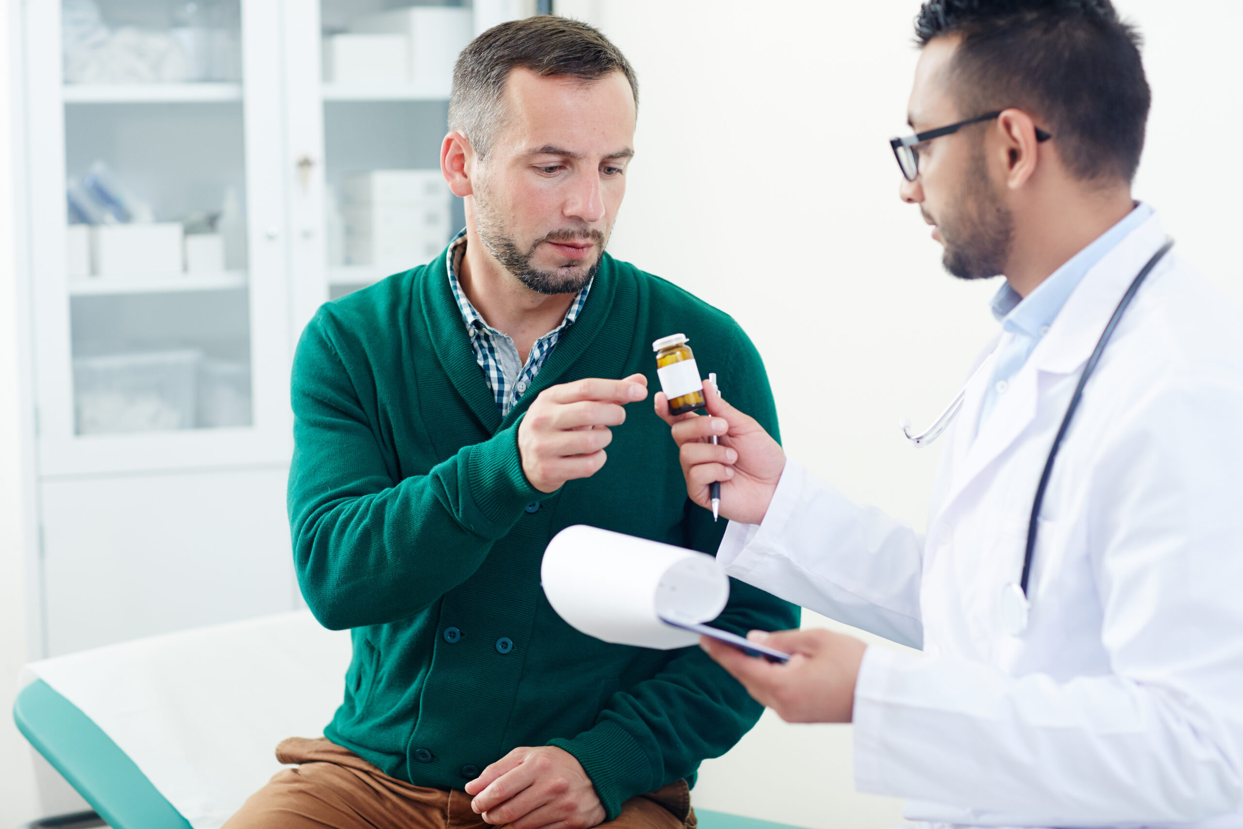 Doctor discussing prescription medication with a patient during a clinical consultation at Kingsland Pharmacy, Mary Street, Southampton.
