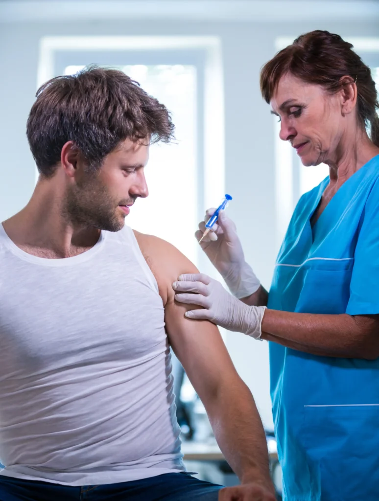 Nurse administering patient injection