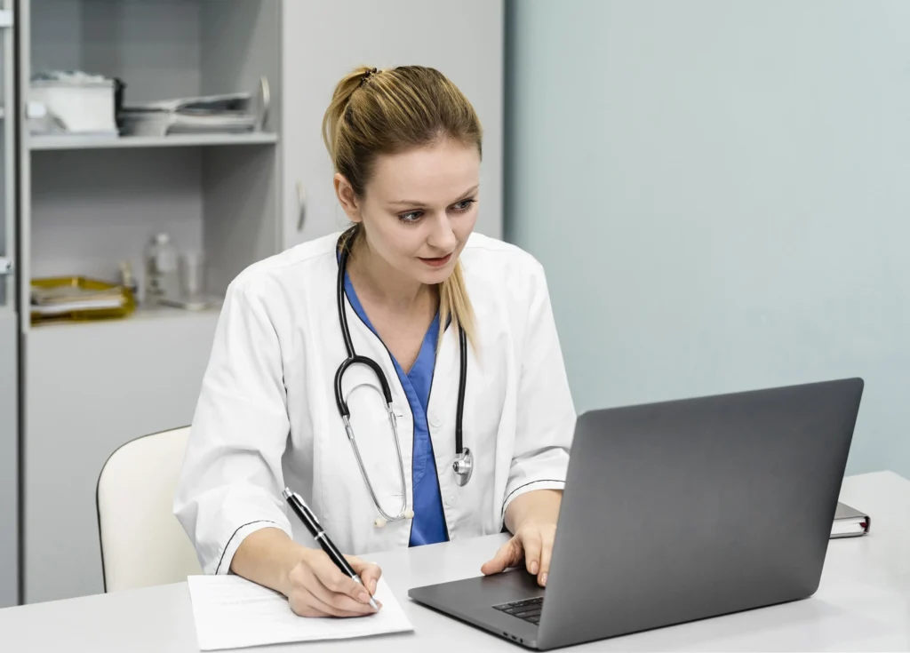 Doctor writing notes at desk