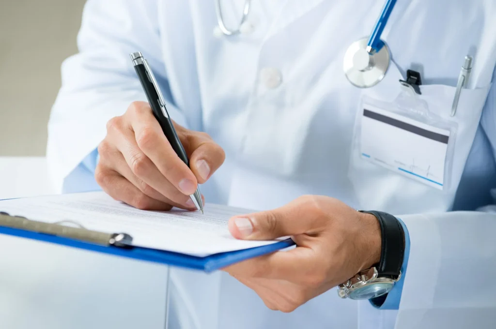 Healthcare professional writing notes on medical clipboard.