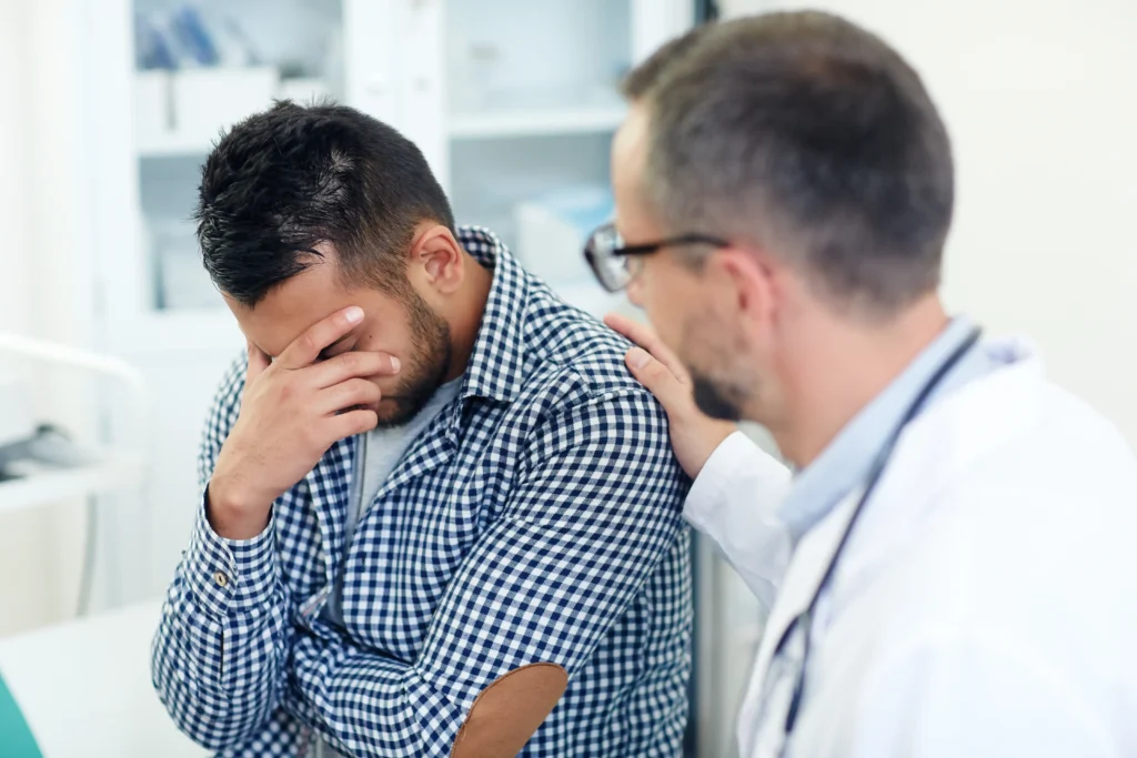 Doctor comforting patient in clinic