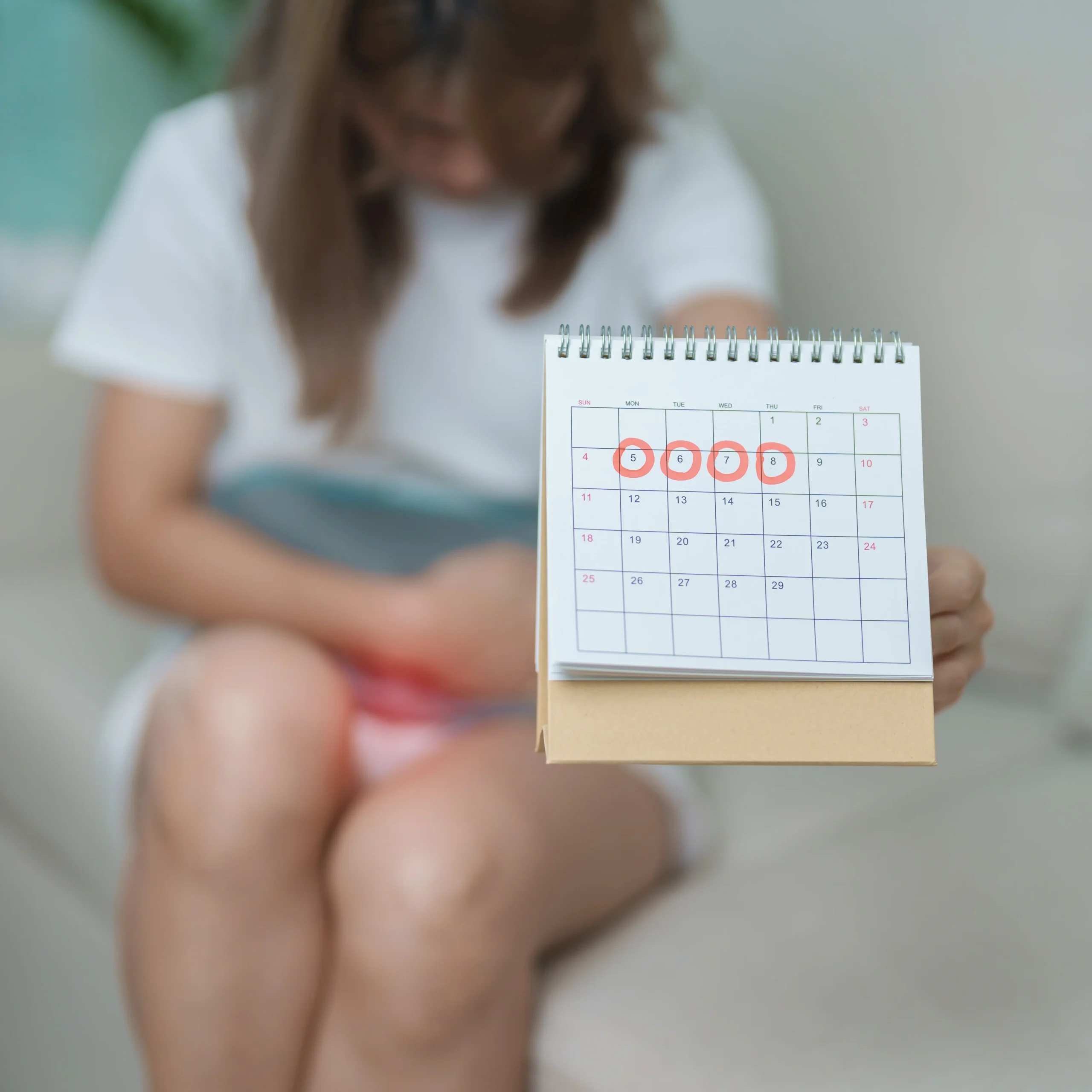 Person holding calendar with dates