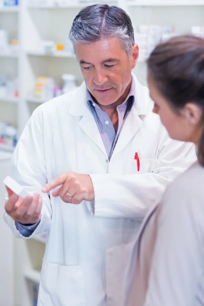 Pharmacist explaining medicine to customer