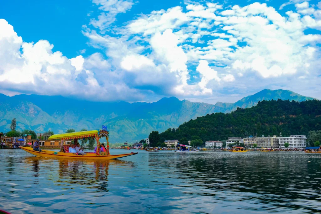 Riding boat in lake before mountains